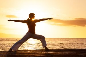 Silhouette of a beautiful Yoga woman in the morning